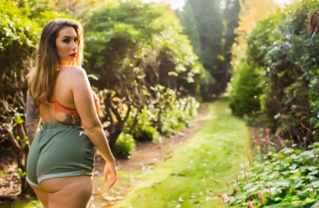 Thick female Paige Turnah exposes her tits in the backyard wearing shorts