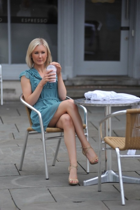 Blond solo girl with nice legs flashes her underwear before undressing at home