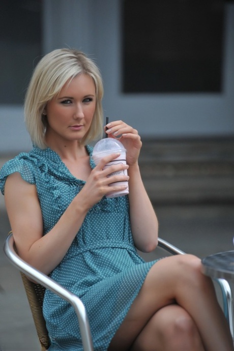 Blond solo girl with nice legs flashes her underwear before undressing at home