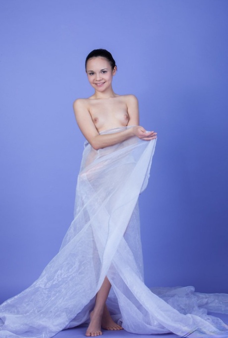 Beautiful brunette teen Ralina wears her hair up during a nude modelling gig