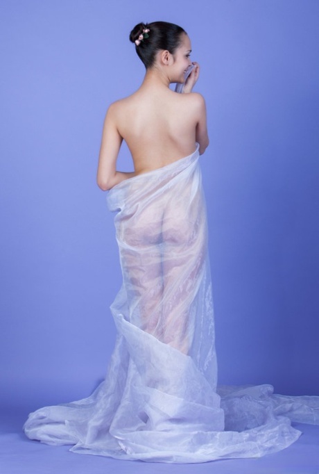 Beautiful brunette teen Ralina wears her hair up during a nude modelling gig