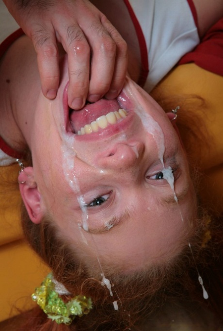 Young redhead wears her hair in pigtails during extreme oral fucking