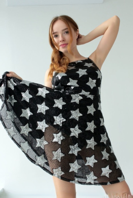 Sweet redheaded teen Rinna Ly unveils her great tits while getting naked