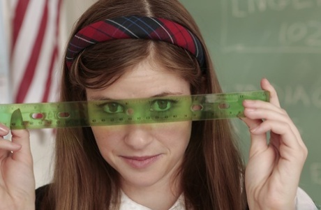 Cute schoolgirl with sexy legs Lara Brookes stripping in the classroom