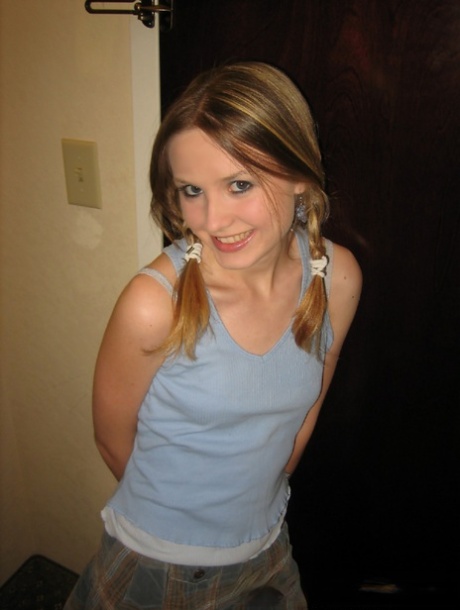 Adorable teen Kitty Kim strips naked behind a closed hotel room door