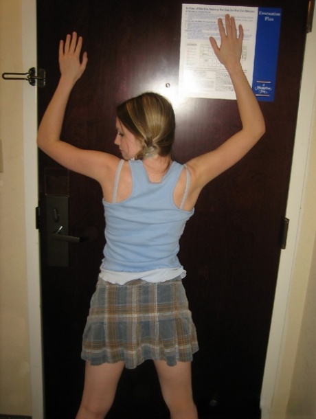 Adorable teen Kitty Kim strips naked behind a closed hotel room door