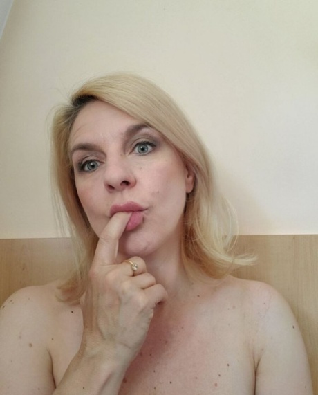 Beautiful mature amateur shows her hot curves while drinking a morning coffee