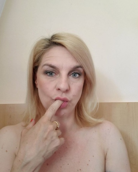 Beautiful mature amateur shows her hot curves while drinking a morning coffee