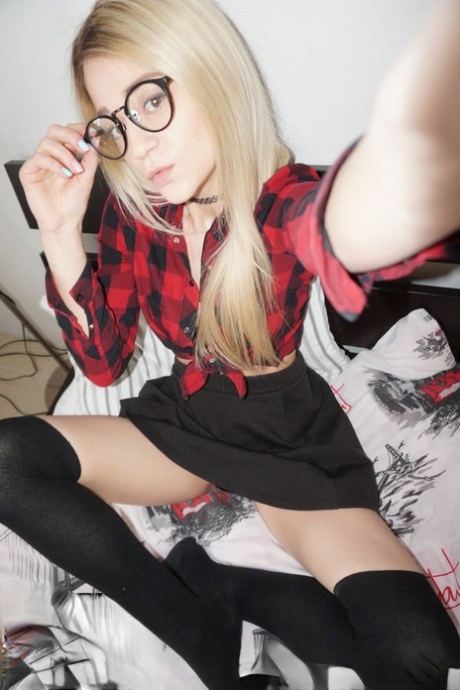 Blonde young amateur in glasses sheds her clothes and takes sexy selfies
