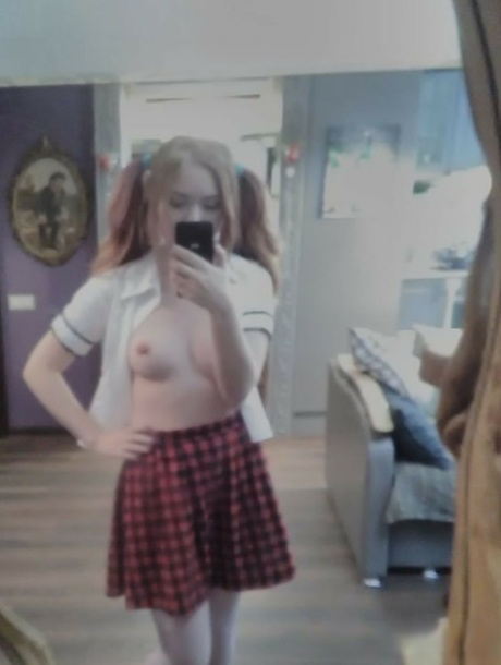 Cute redheaded amateur exposes her sweet nips and poses in a solo