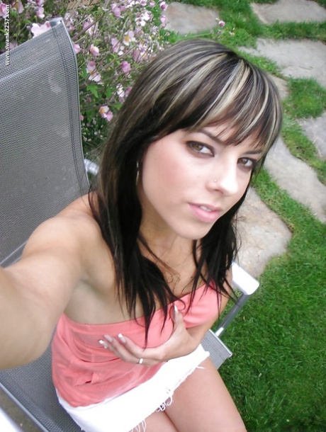 Cute brunette girl with big tits undressing outdoor and posing