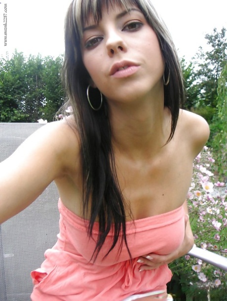 Cute brunette girl with big tits undressing outdoor and posing