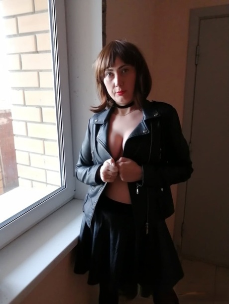 Amateur MILF in stockings exposes her ass and natural tits on the stairs