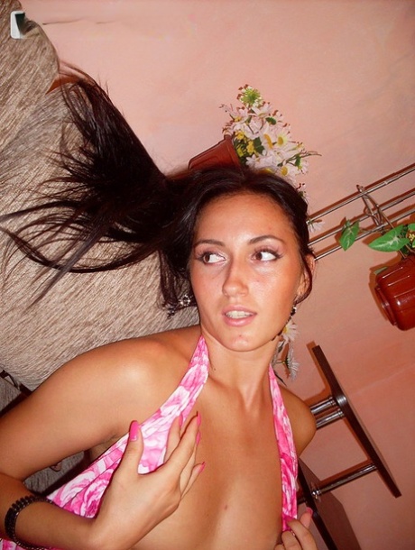 Brunette amateur Viktoria strips to a thong during indoor solo action