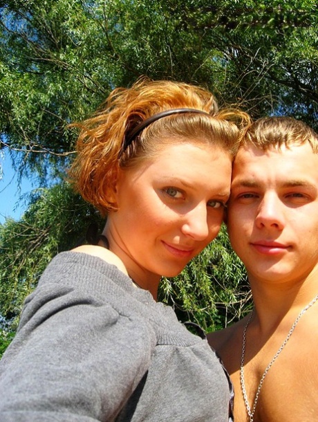 Amateur girl with red hair changes into a bikini before getting in the ocean