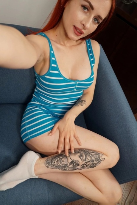 Beautiful redhead presents her firm big boobs and poses at her home