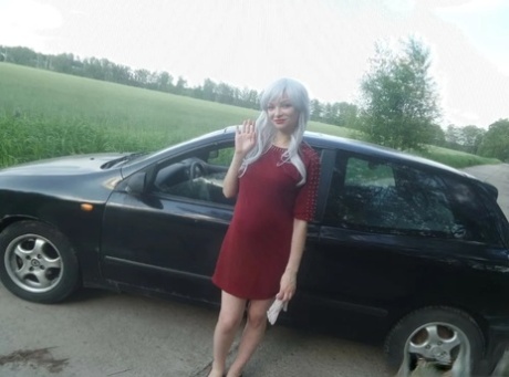 Sensational blonde babe flaunts her incredible big booty in front of a car