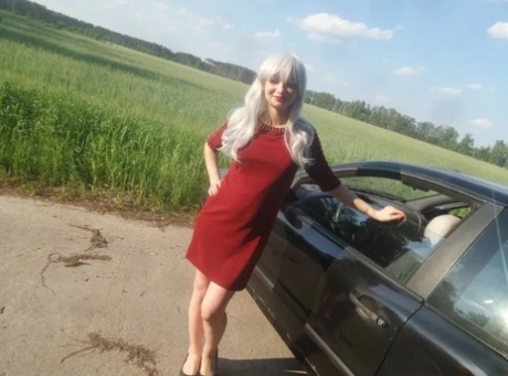 Sensational blonde babe flaunts her incredible big booty in front of a car