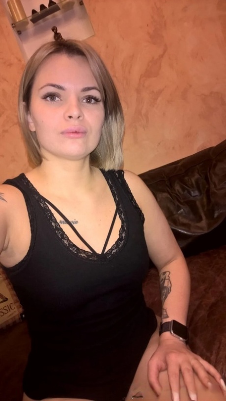 Blonde babe shows her small tits & her shaved pussy in black lingerie