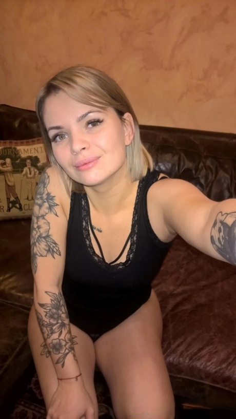 Blonde babe shows her small tits & her shaved pussy in black lingerie