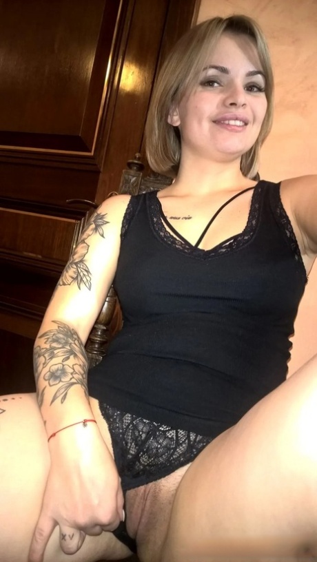 Blonde babe shows her small tits & her shaved pussy in black lingerie