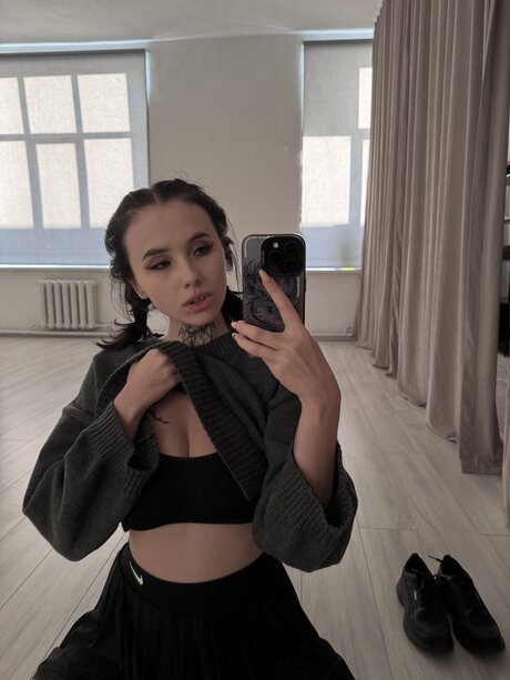 Brunette teen Beatrice Bell shows her tongue while wearing knee socks