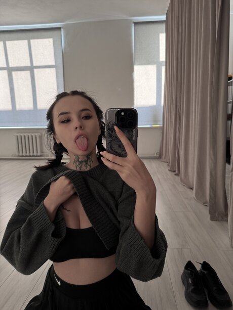 Brunette teen Beatrice Bell shows her tongue while wearing knee socks