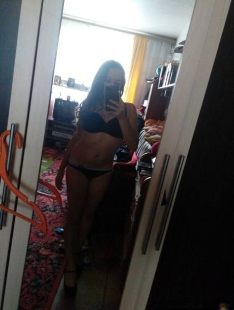 Naughty amateur teen poses in the mirror for selfies in hot outfits & lingerie