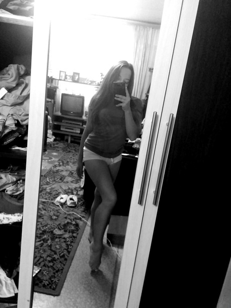 Naughty amateur teen poses in the mirror for selfies in hot outfits & lingerie