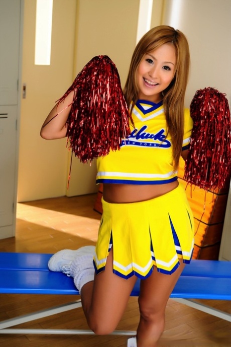 Adorable Japanese cheerleader uncovers great tits before showing her pussy