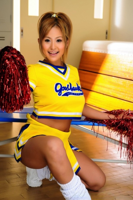 Adorable Japanese cheerleader uncovers great tits before showing her pussy