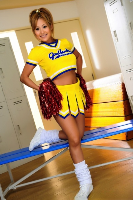 Adorable Japanese cheerleader uncovers great tits before showing her pussy