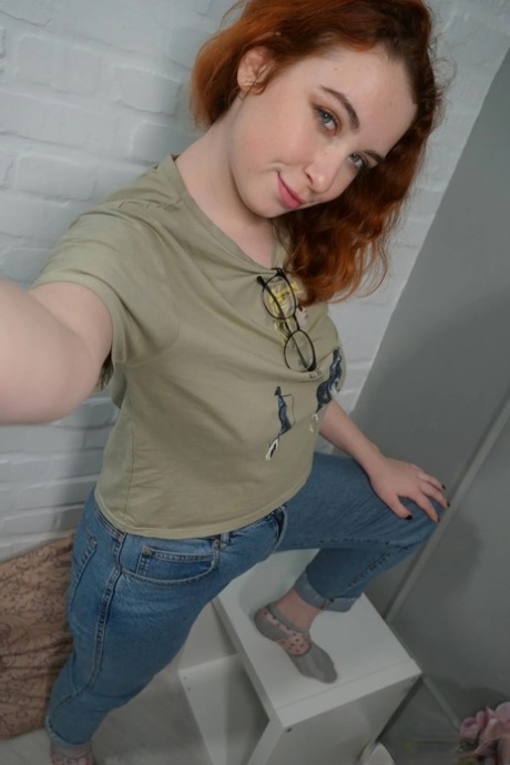 Lovely redhead takes nude selfies showing her juicy tits & her big ass