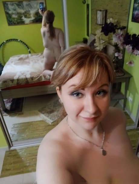 Petite MILF poses in the mirror and teases with her bubble ass and lovely tits