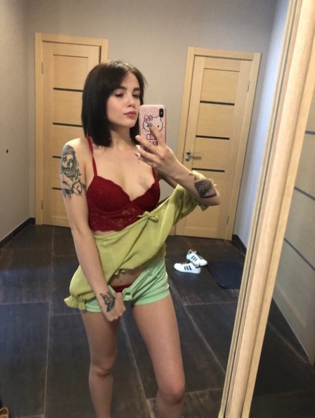 Sweet inked teen Morena Marianotarta strips naked and poses in the mirror