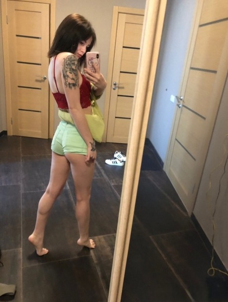 Sweet inked teen Morena Marianotarta strips naked and poses in the mirror