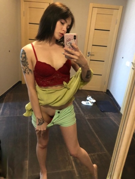 Sweet inked teen Morena Marianotarta strips naked and poses in the mirror