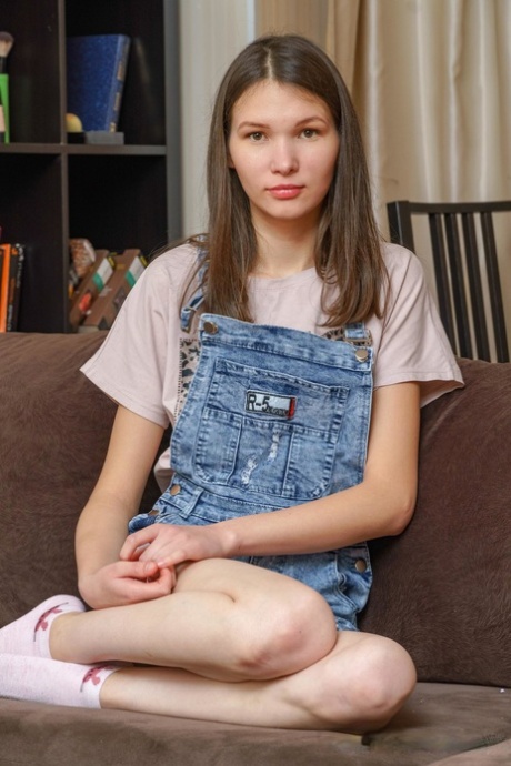 Pretty teen babe Mellissa gently fingers her delicious pussy on the sofa