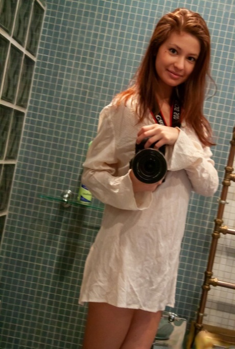 Sweet teen Irina J shows her tight ass and slit while in the bathroom