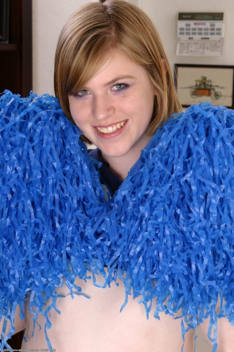 Blonde cheerleader Elizabeth shows off her tits & spreads her shaved pussy