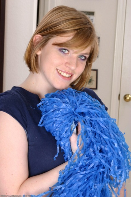 Blonde cheerleader Elizabeth shows off her tits & spreads her shaved pussy