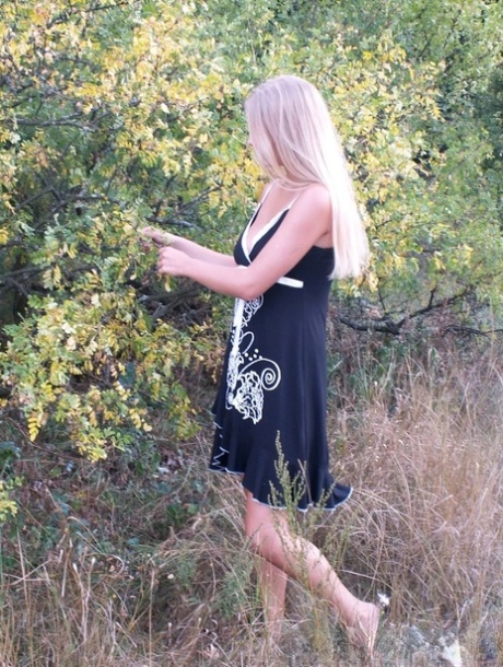 Naughty blonde strips naked & shows off her tanned tits outdoors