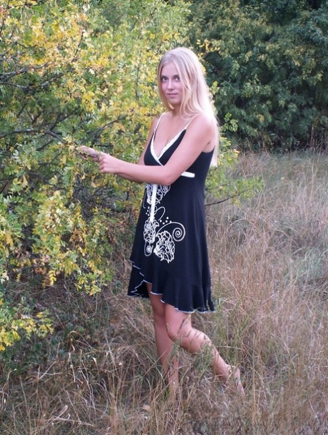 Naughty blonde strips naked & shows off her tanned tits outdoors