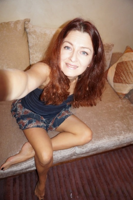 Naughty redheaded amateur MILF stripping and posing to take sexy selfies
