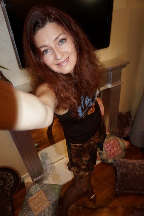 Naughty redheaded amateur MILF stripping and posing to take sexy selfies