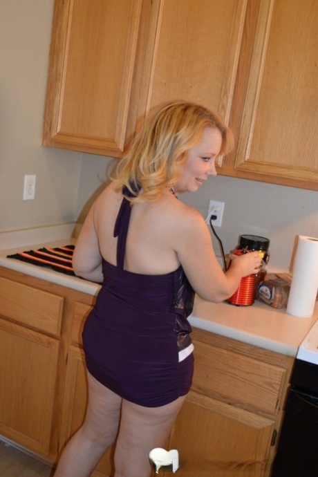 Mature blonde strips in the kitchen & rubs her juicy tits and hot pussy