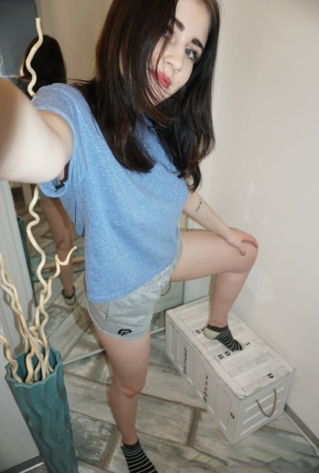 Dark-haired cutie posing butt naked and in her sexy lingerie in a solo