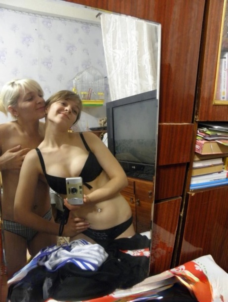 Lesbian babes strip and suck each other's tits while taking selfies
