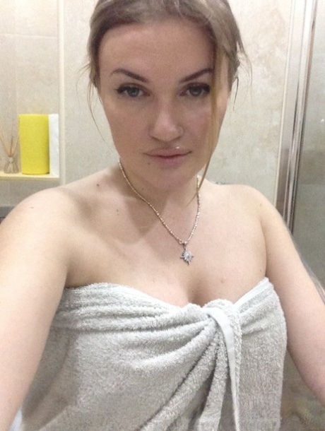 Blonde amateur shows off her juicy breasts & pussy while taking nude selfies