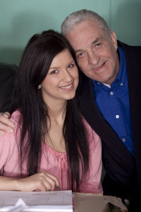 Dark haired teen performs oral sex on her aging sugar daddy